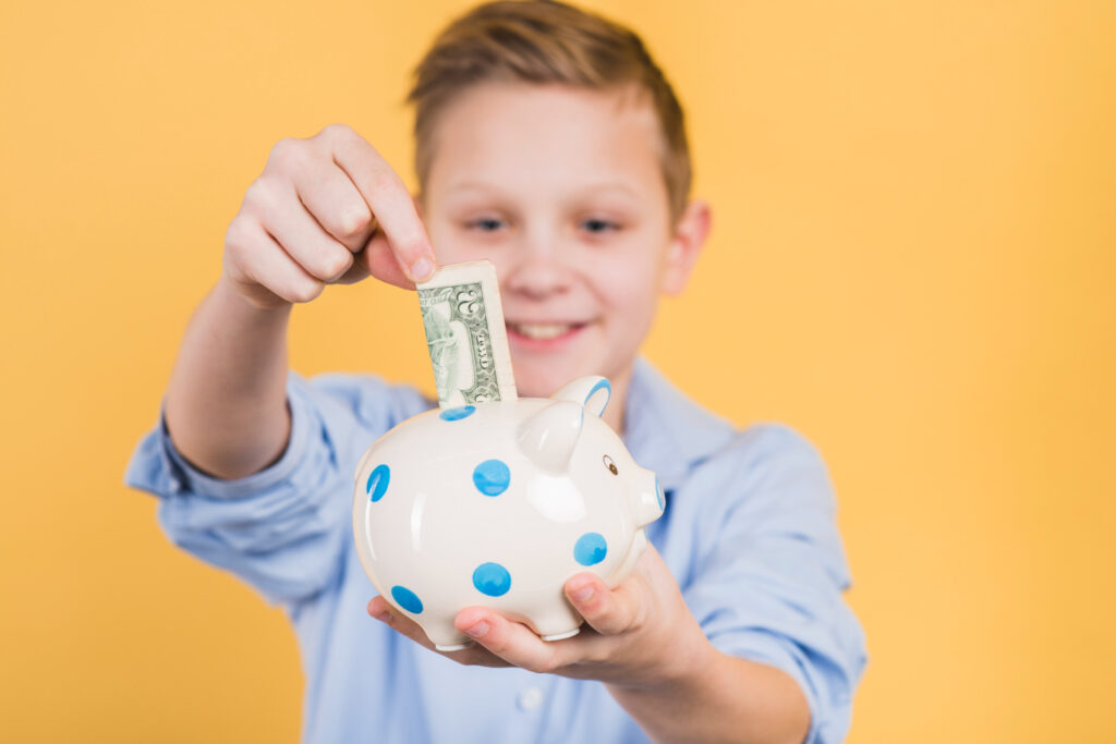 Boy holding a piggy bank