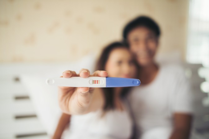 Parents showing a pregnancy test