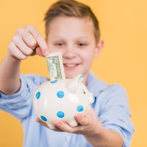 Boy holding a piggy bank